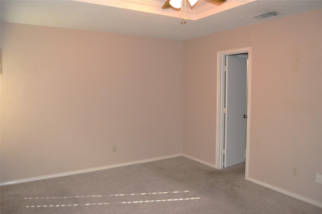 unfurnished room featuring ceiling fan, light colored carpet, and a textured ceiling