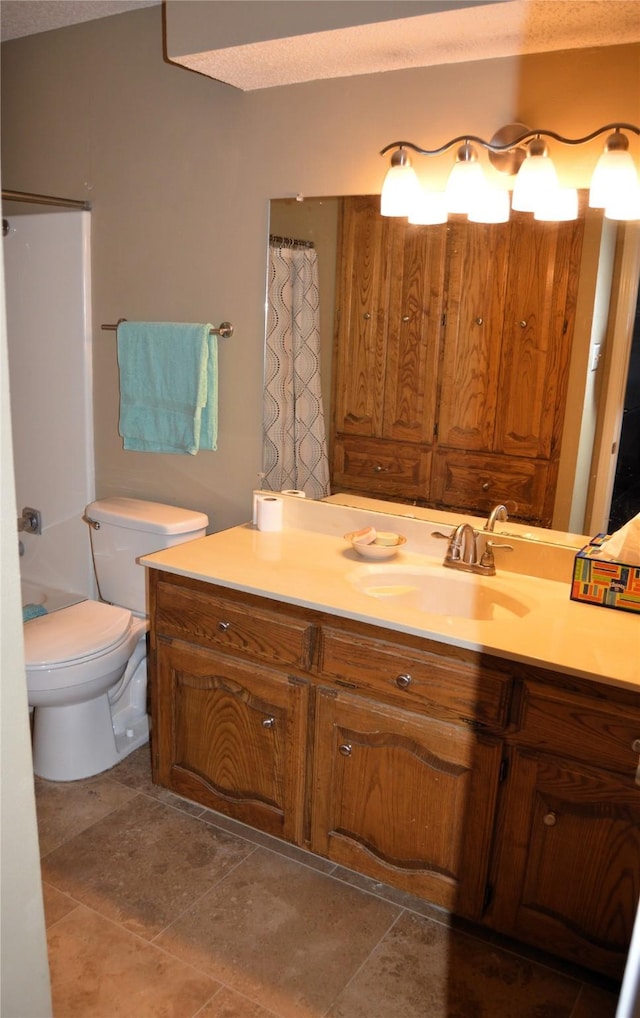 bathroom with vanity, toilet, and curtained shower