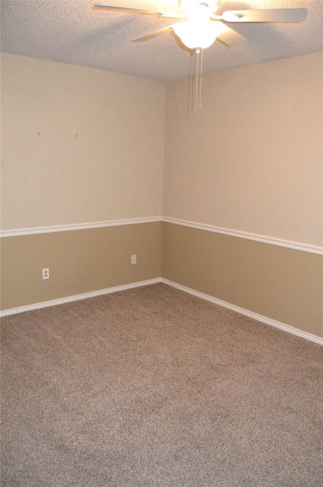 carpeted empty room with ceiling fan and a textured ceiling