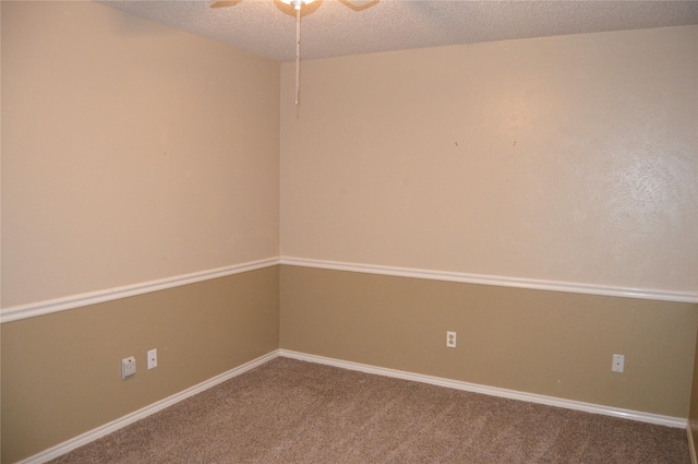 spare room featuring ceiling fan, carpet, and a textured ceiling