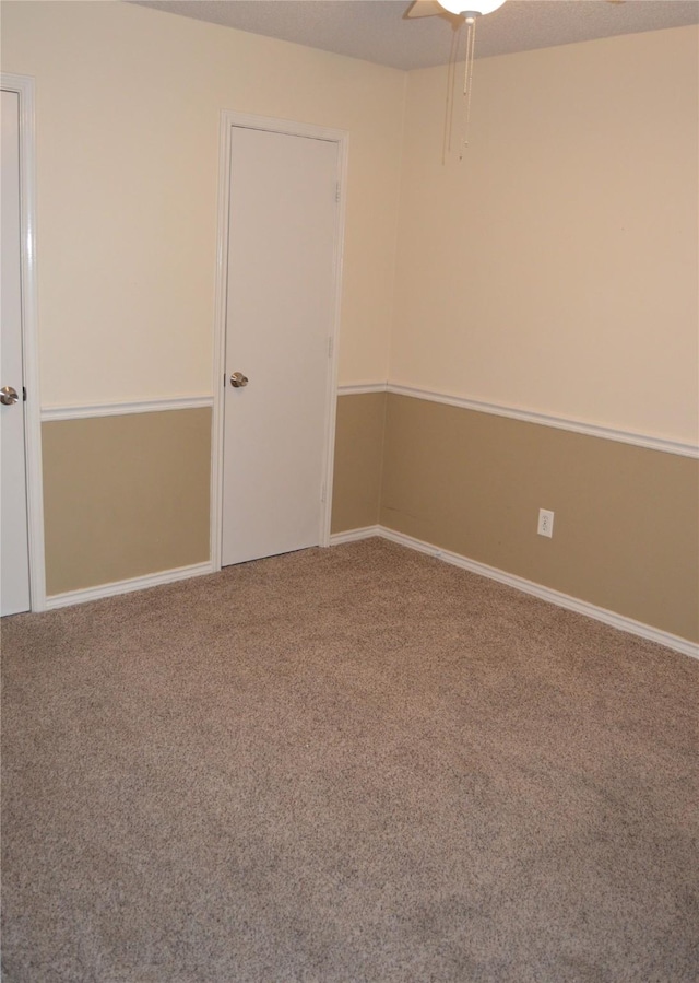 carpeted spare room with a textured ceiling