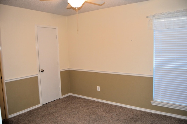 spare room featuring ceiling fan, carpet floors, and a textured ceiling