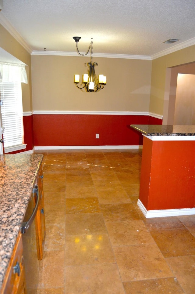 kitchen featuring crown molding, pendant lighting, a textured ceiling, and a notable chandelier