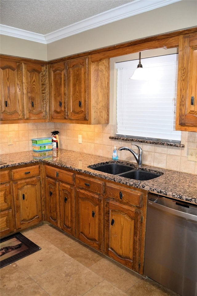 kitchen featuring dishwasher, sink, dark stone countertops, and crown molding