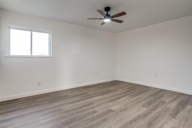 empty room with light hardwood / wood-style flooring and ceiling fan