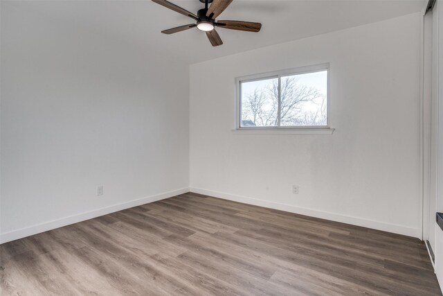 empty room featuring ceiling fan and hardwood / wood-style floors