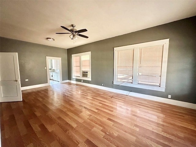 interior space with cooling unit, ceiling fan, and hardwood / wood-style floors