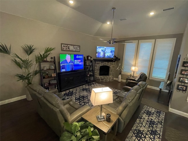 living room with lofted ceiling, visible vents, baseboards, a fireplace, and a ceiling fan
