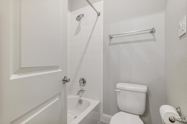 bathroom featuring bathing tub / shower combination and toilet