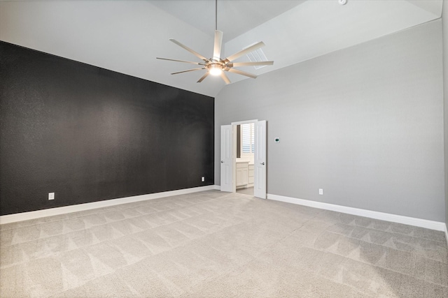 carpeted empty room with high vaulted ceiling and ceiling fan