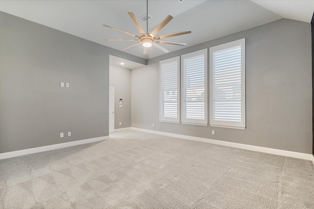 unfurnished room with light carpet, vaulted ceiling, and ceiling fan