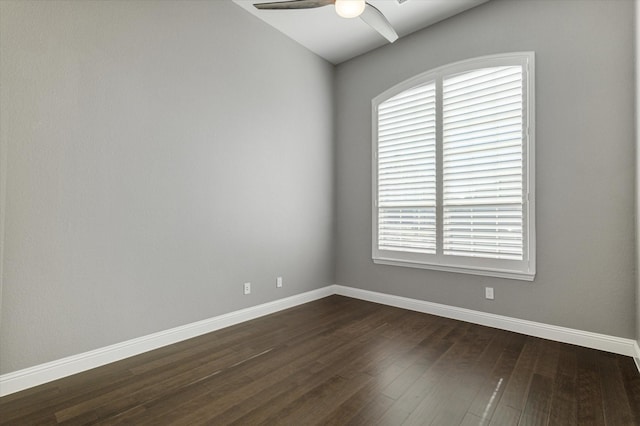 spare room with dark wood-type flooring and ceiling fan