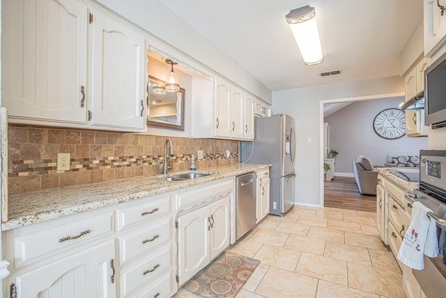 kitchen with white cabinetry, appliances with stainless steel finishes, and sink