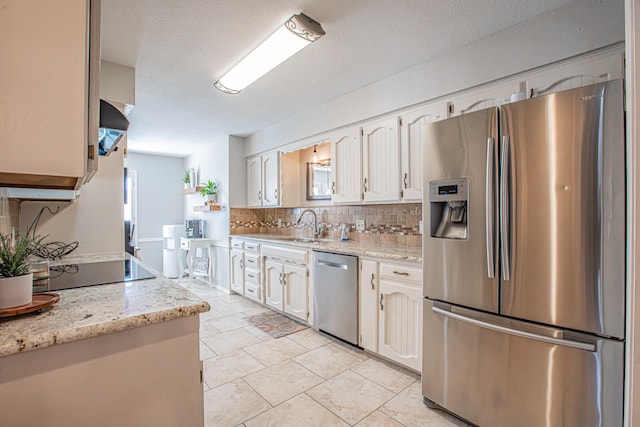 kitchen featuring white cabinetry, decorative backsplash, stainless steel appliances, and light stone counters