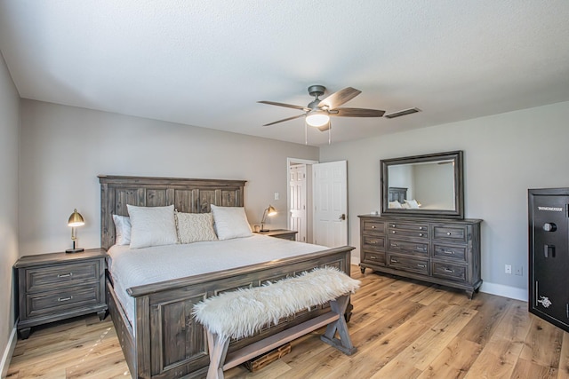 bedroom with light hardwood / wood-style flooring and ceiling fan