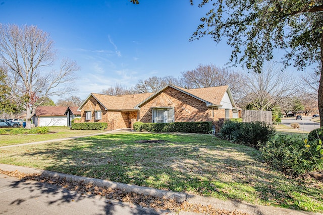 ranch-style house featuring a garage and a front yard