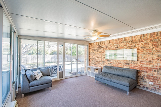 sunroom / solarium featuring ceiling fan