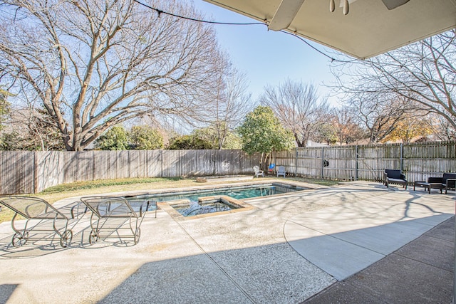 view of pool featuring a patio, ceiling fan, and an in ground hot tub