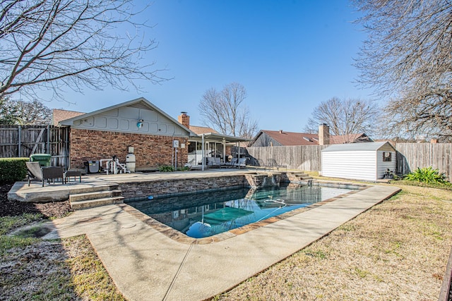 view of pool with a patio and a storage shed