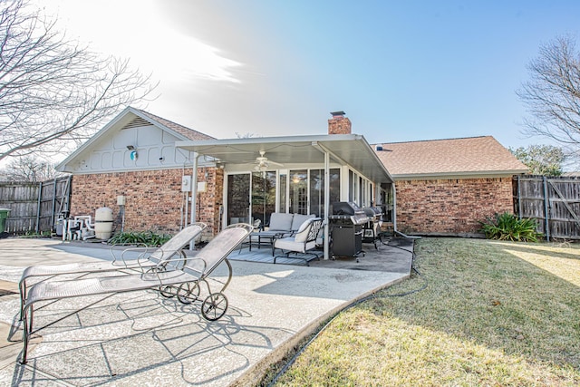 back of house featuring outdoor lounge area, a lawn, ceiling fan, and a patio area