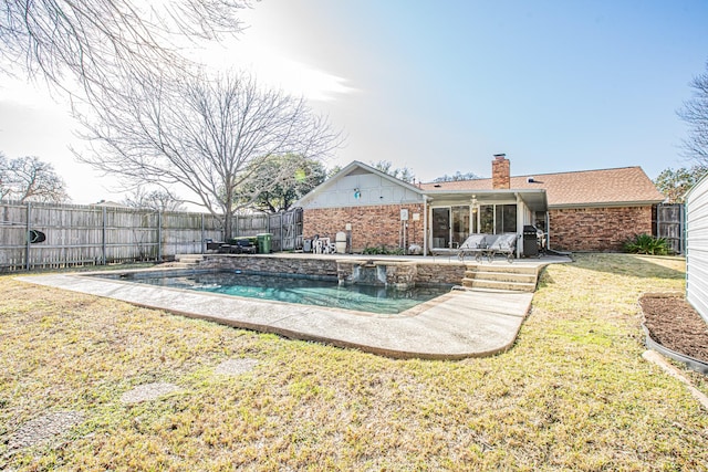 view of swimming pool featuring a yard and a patio area