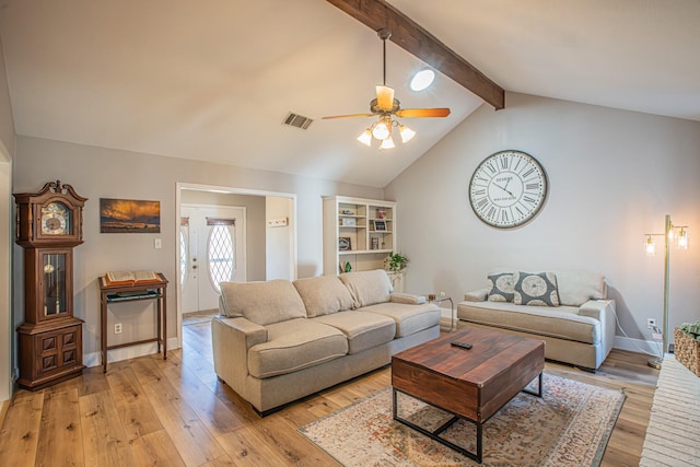 living room with ceiling fan, light hardwood / wood-style floors, and vaulted ceiling with beams