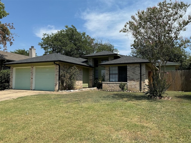 view of front of property with a garage and a front yard