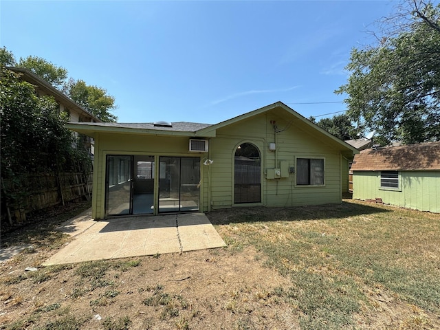 rear view of property with a yard and a patio area