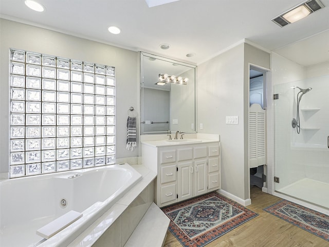 bathroom with wood-type flooring, vanity, and separate shower and tub