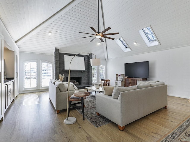 living room featuring hardwood / wood-style floors, ceiling fan, wooden ceiling, and a brick fireplace