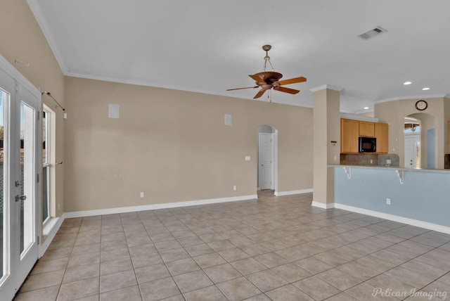 unfurnished room featuring light tile patterned floors, crown molding, and ceiling fan