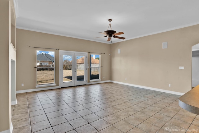 empty room featuring crown molding, light tile patterned flooring, ceiling fan, and french doors