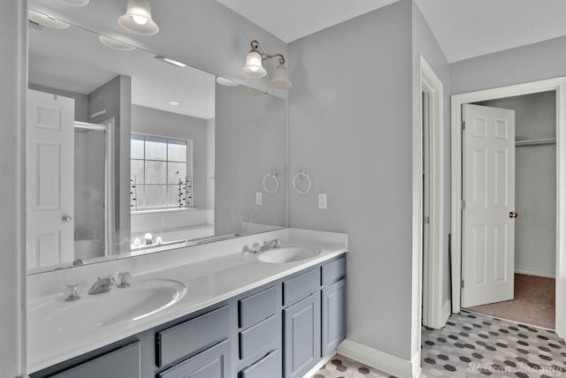 bathroom with vanity and a shower with door