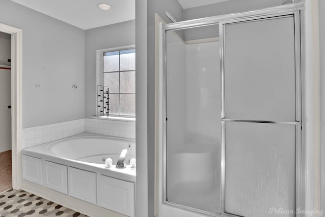 bathroom featuring separate shower and tub