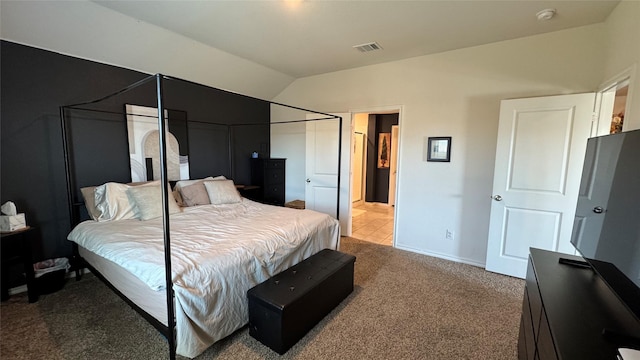 bedroom featuring lofted ceiling and carpet floors