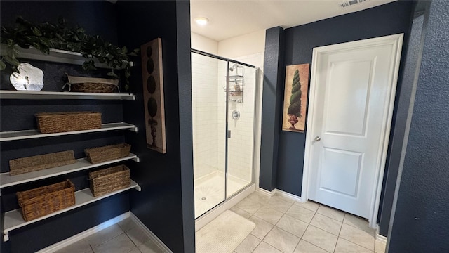 bathroom with walk in shower and tile patterned flooring