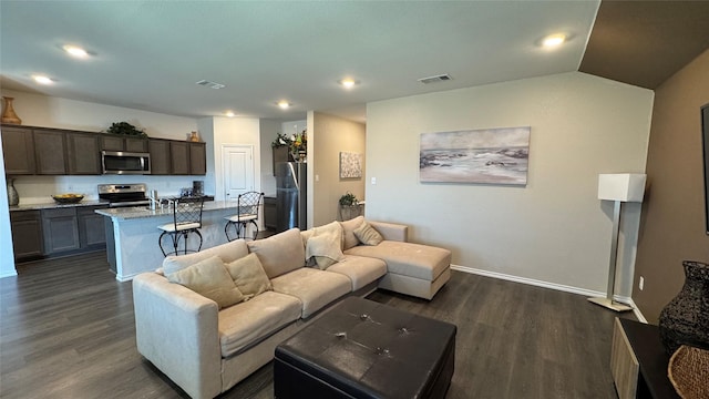 living room with lofted ceiling and dark hardwood / wood-style flooring