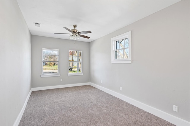 carpeted spare room with ceiling fan