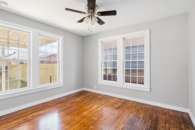 empty room featuring hardwood / wood-style floors and ceiling fan