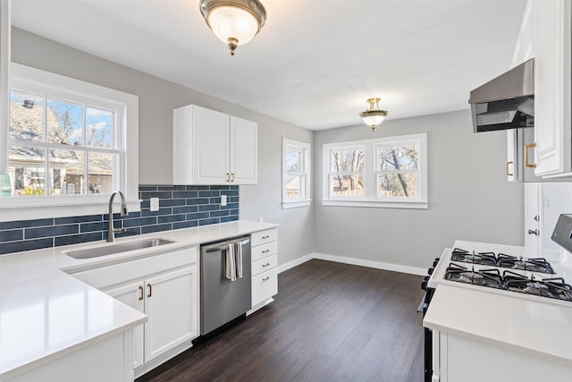 kitchen with dishwasher, white cabinets, wall chimney range hood, and sink