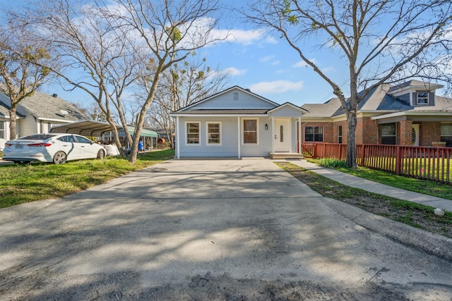 view of front of house with a carport, a porch, and a front yard