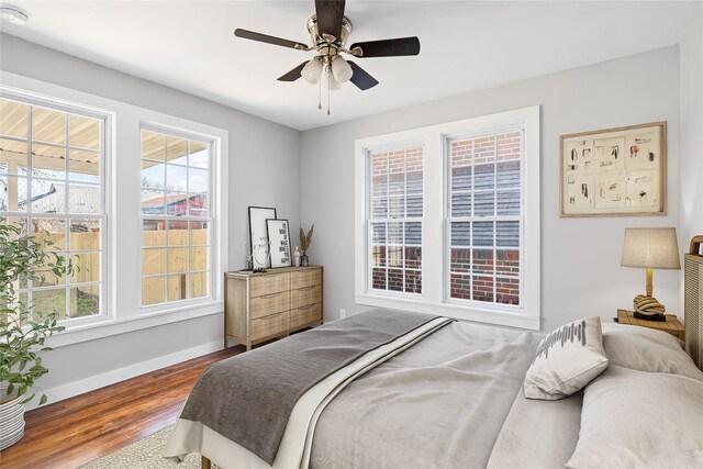 702 N Church St, Decatur, TX 76234 - bedroom featuring wood finished floors, multiple windows, and a ceiling fan