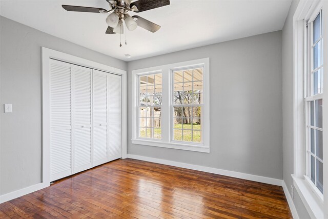 702 N Church St, Decatur, TX 76234 - unfurnished bedroom featuring wood-type flooring, a closet, and ceiling fan