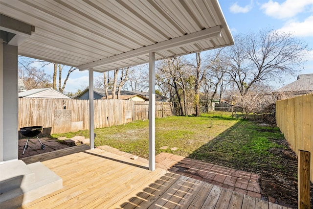 wooden terrace featuring a yard