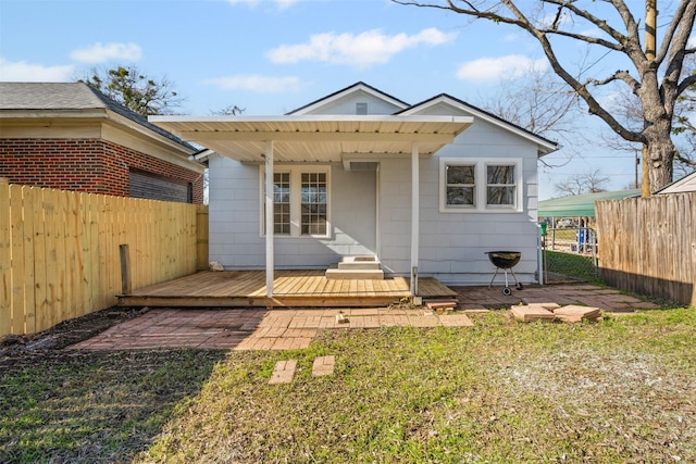 rear view of property featuring a yard