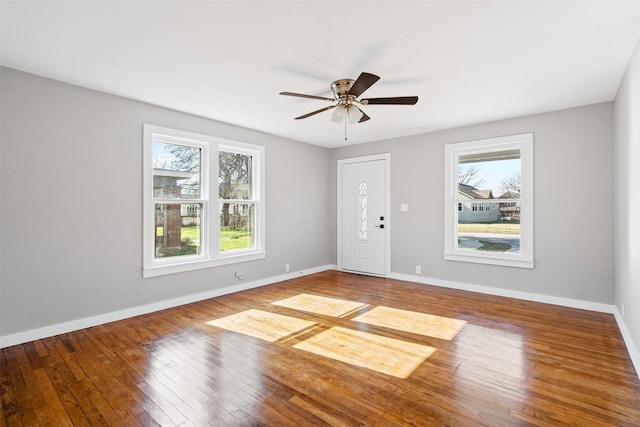 empty room with ceiling fan and hardwood / wood-style flooring