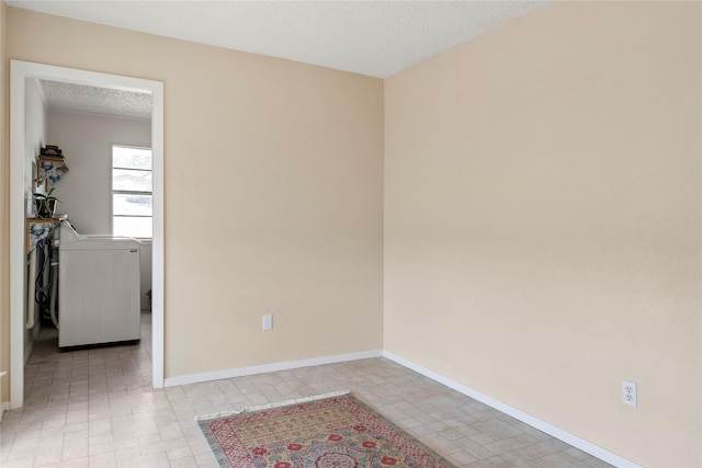 spare room featuring a textured ceiling and washer and clothes dryer