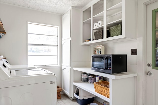 clothes washing area featuring separate washer and dryer and a textured ceiling