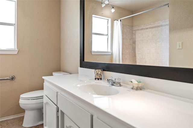 bathroom with walk in shower, tile patterned flooring, vanity, and toilet