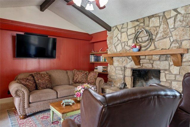 living room with a fireplace, lofted ceiling with beams, and ceiling fan